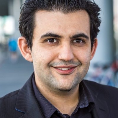 Head shot of a man in a black suit.